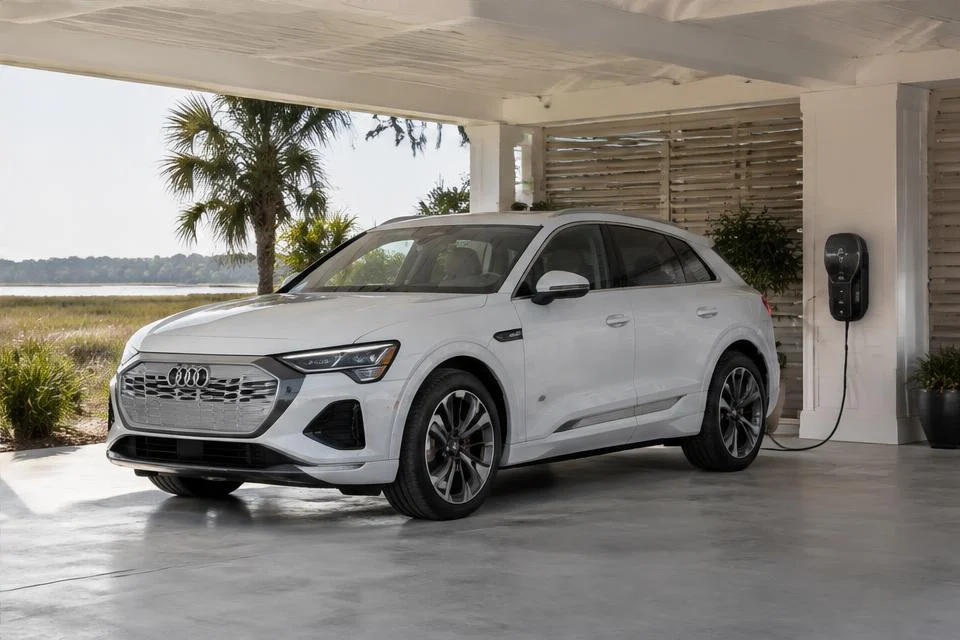 Original AI-generated illustration: White Audi Q8 e-tron-inspired electric SUV beside a carport wall charger