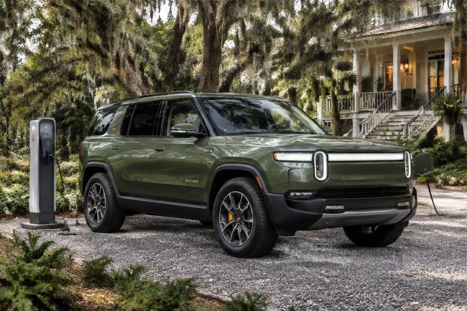 Original AI-generated illustration: Green Rivian R1S-inspired electric SUV parked beside an outdoor charging pedestal